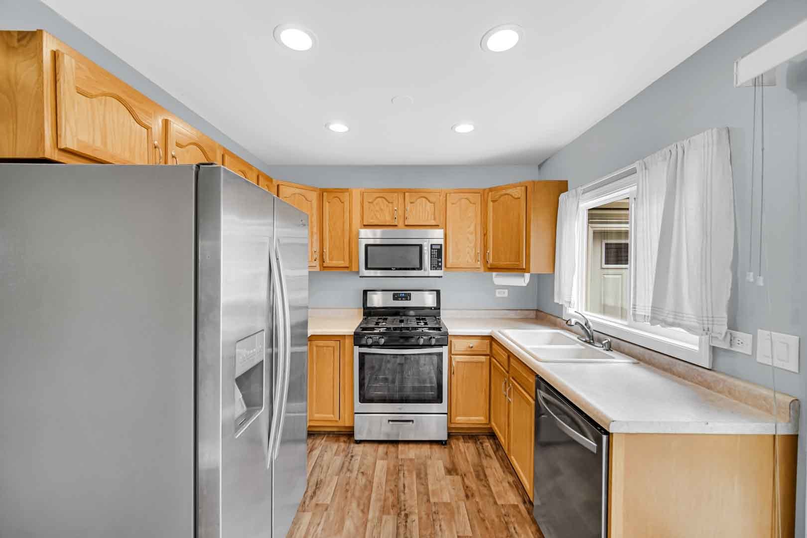 9215 Fox Court Orland Hills, IL 60487 - Photo 10 of 21 a kitchen with stainless steel appliances granite countertop a sink stove and refrigerator
