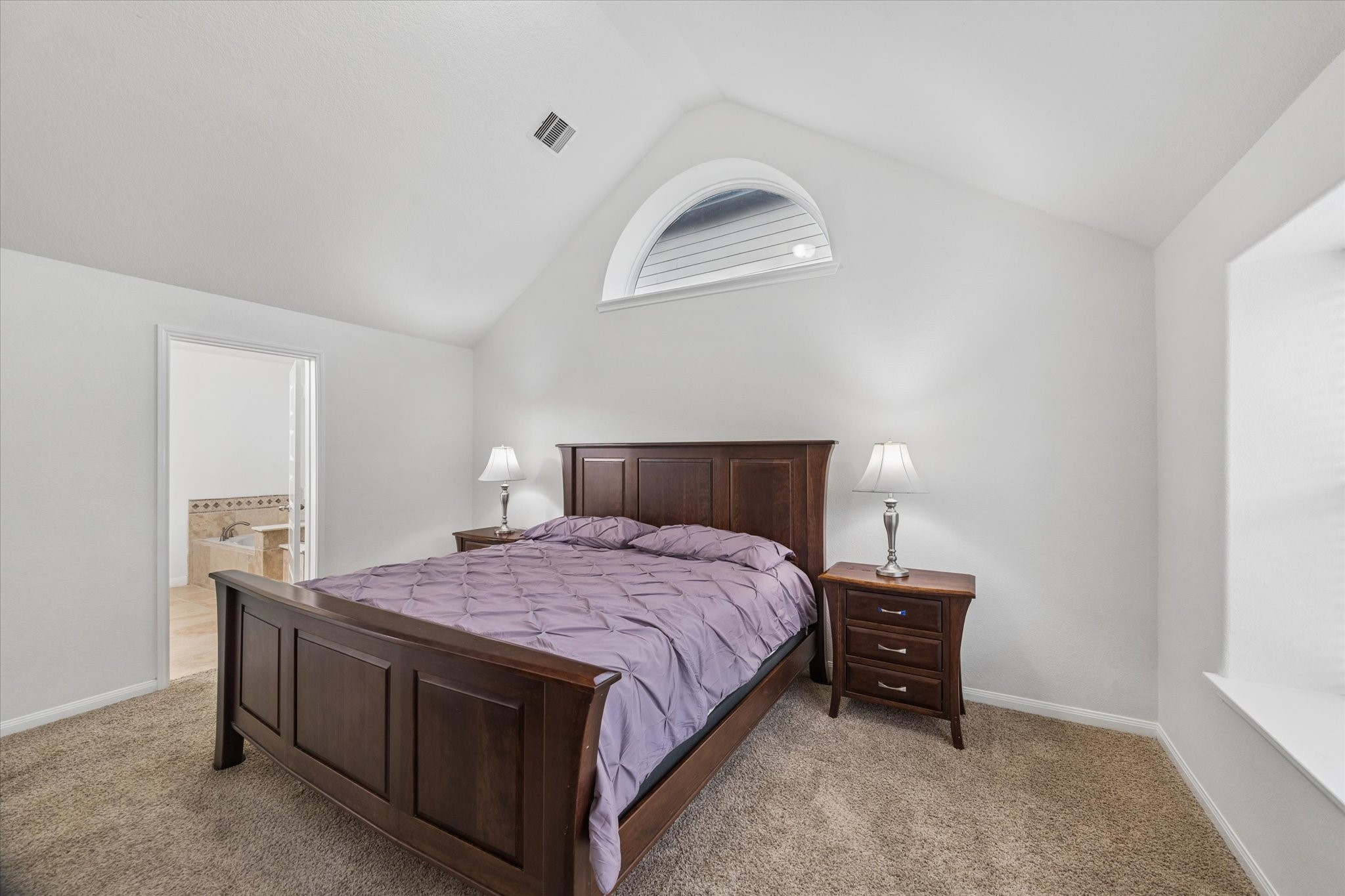 7015 Riata Hills Lane Spring, TX 77379 - Photo 15 of 33 The vaulted ceiling adds wonderful volume to the room, while the arched window brings in soft natural light and architectural character.