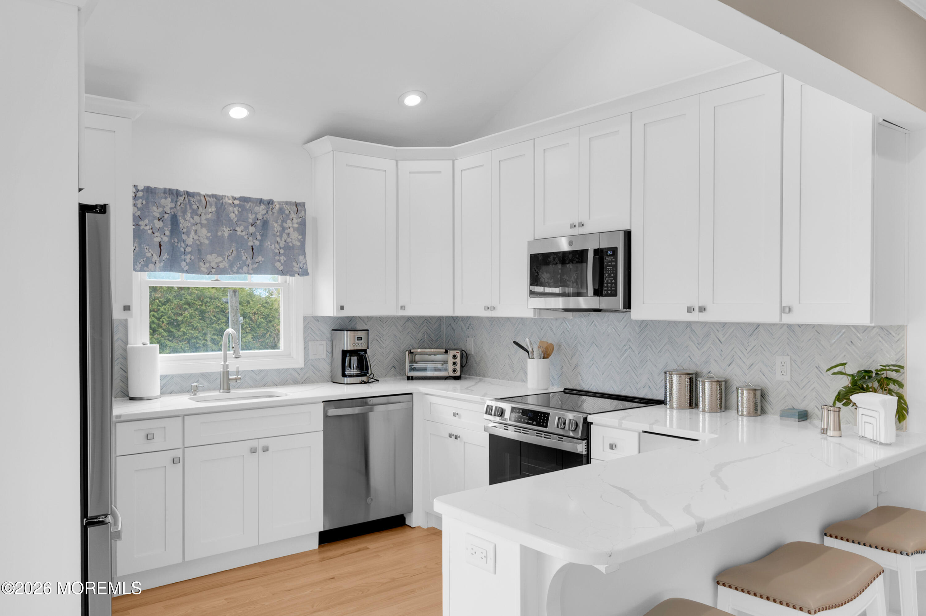 a kitchen with a sink stove and microwave