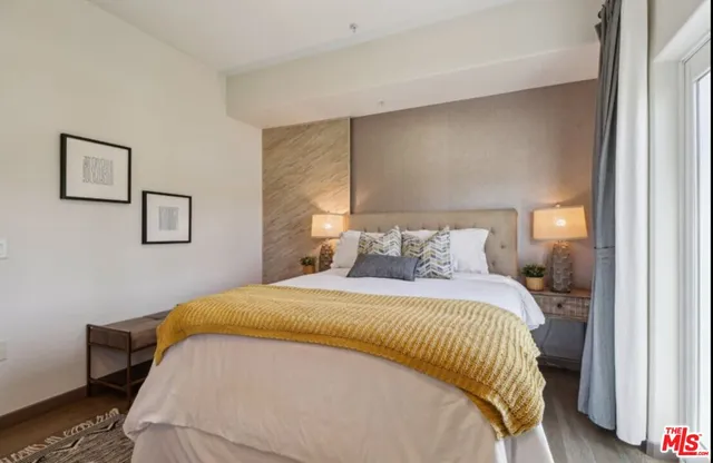 a bedroom with a bed closet and mirror