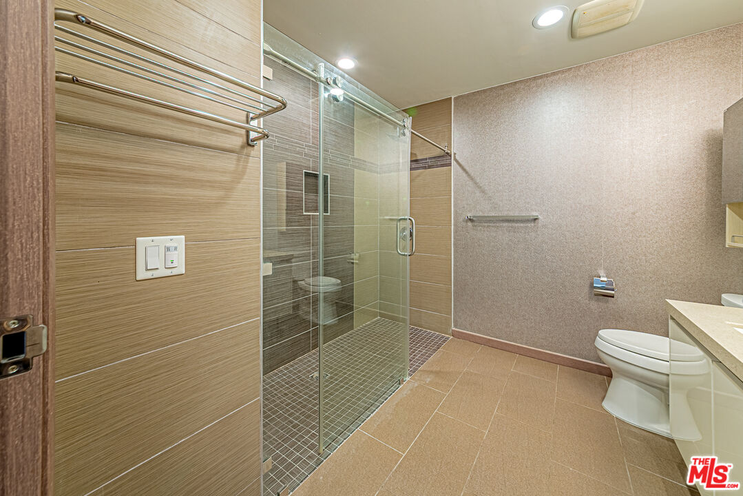 903 South New Hampshire Avenue, Unit 303 Los Angeles, CA 90006 - Photo 16 of 33 a bathroom with a toilet and a shower