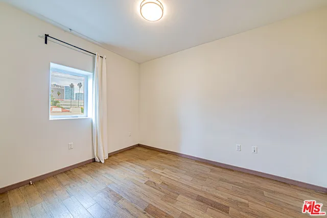 an empty room with wooden floor and closet