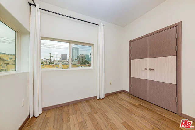 a view of an empty room with wooden floor