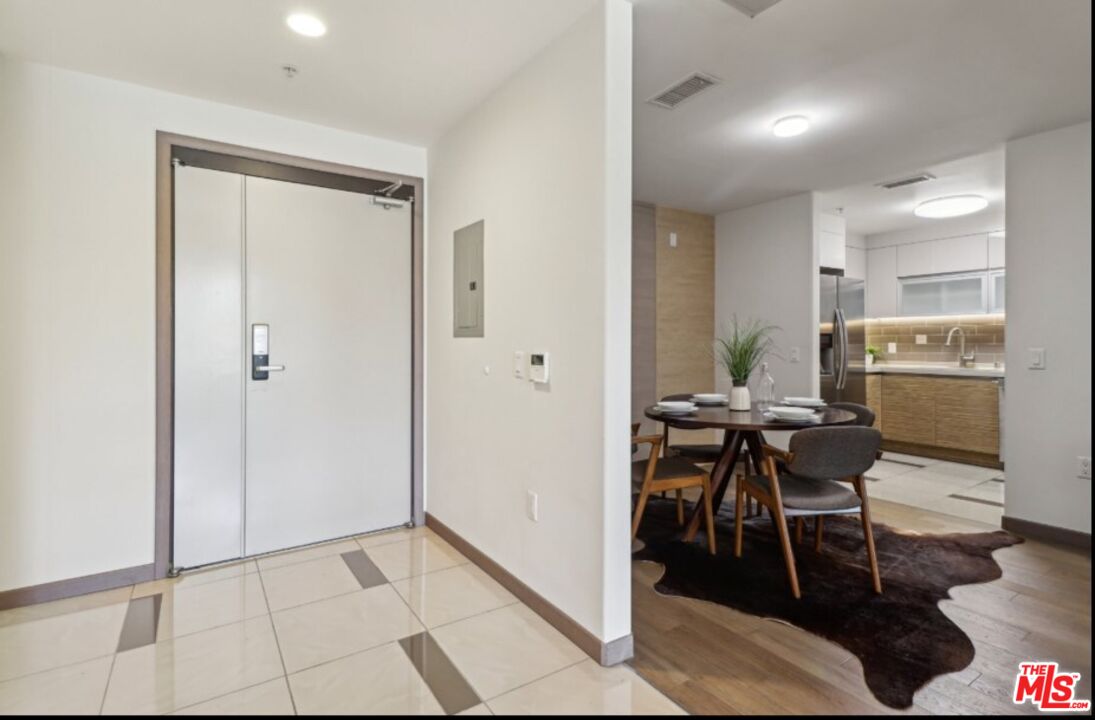 903 South New Hampshire Avenue, Unit 303 Los Angeles, CA 90006 - Photo 3 of 33 a view of a dining room with furniture and a chandelier