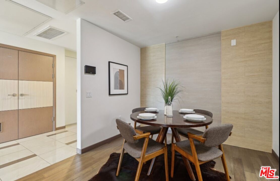 903 South New Hampshire Avenue, Unit 303 Los Angeles, CA 90006 - Photo 4 of 33 a view of a dining room with furniture and wooden floor