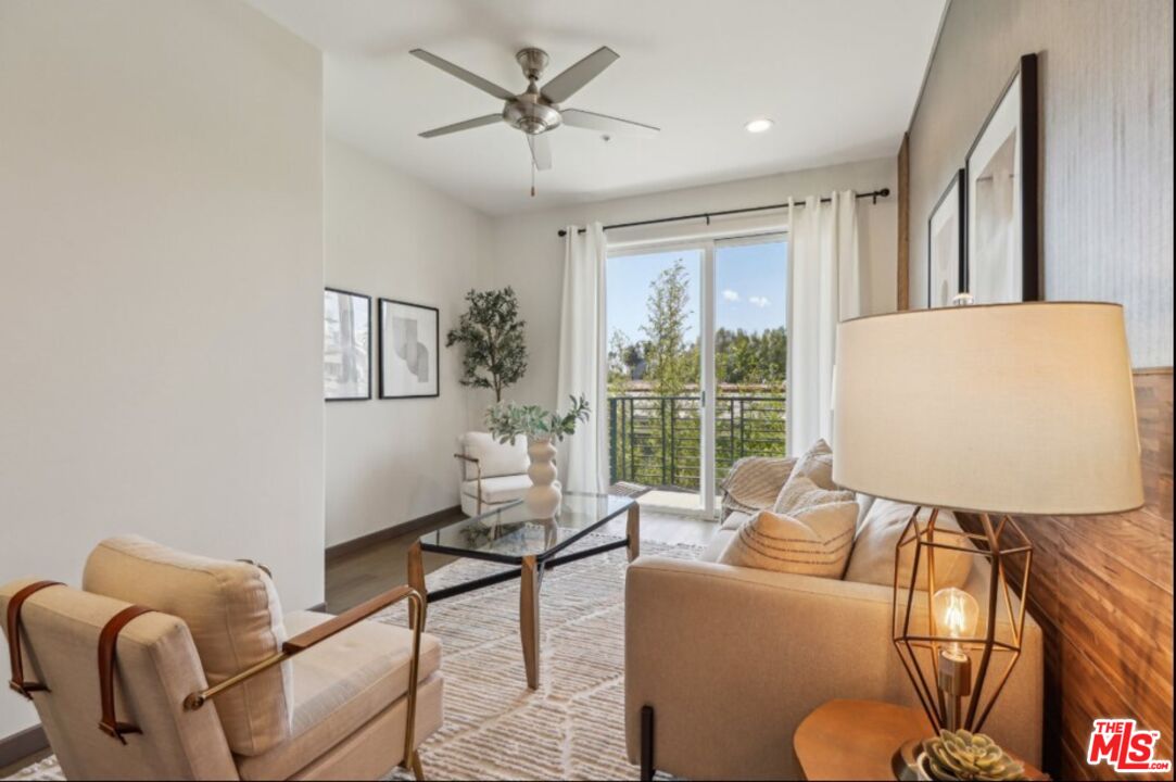 903 South New Hampshire Avenue, Unit 303 Los Angeles, CA 90006 - Photo 8 of 33 a living room with furniture and a large window