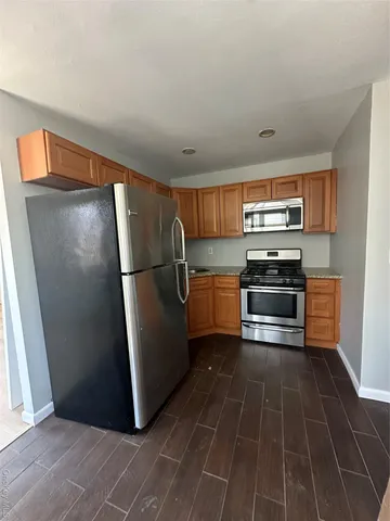 a kitchen with a refrigerator and a sink