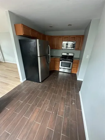 a kitchen with granite countertop a refrigerator and a stove