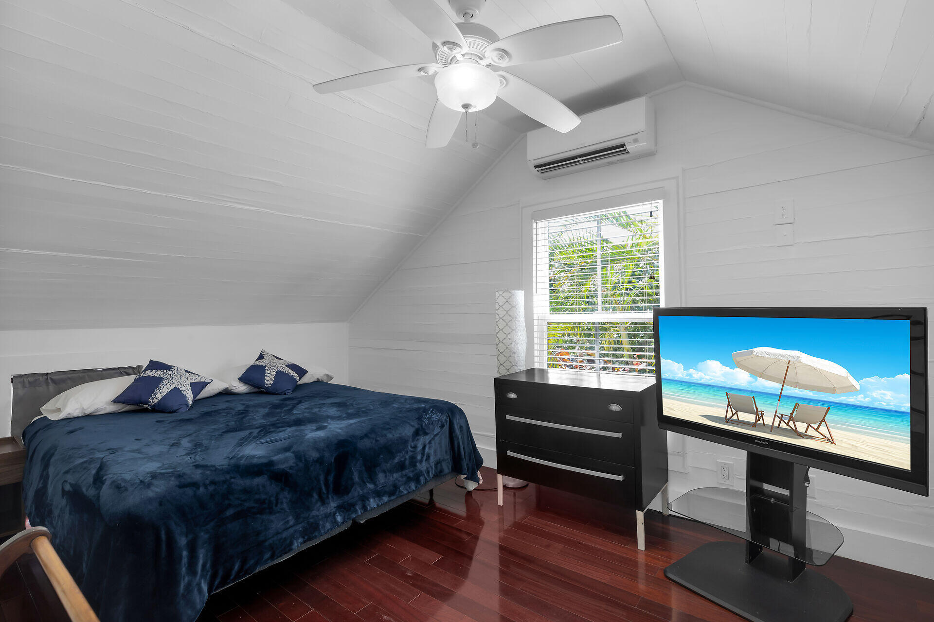 1124 Eaton Street Key West, FL 33040 - Photo 15 of 28 a bedroom with a bed and a dresser next to a window