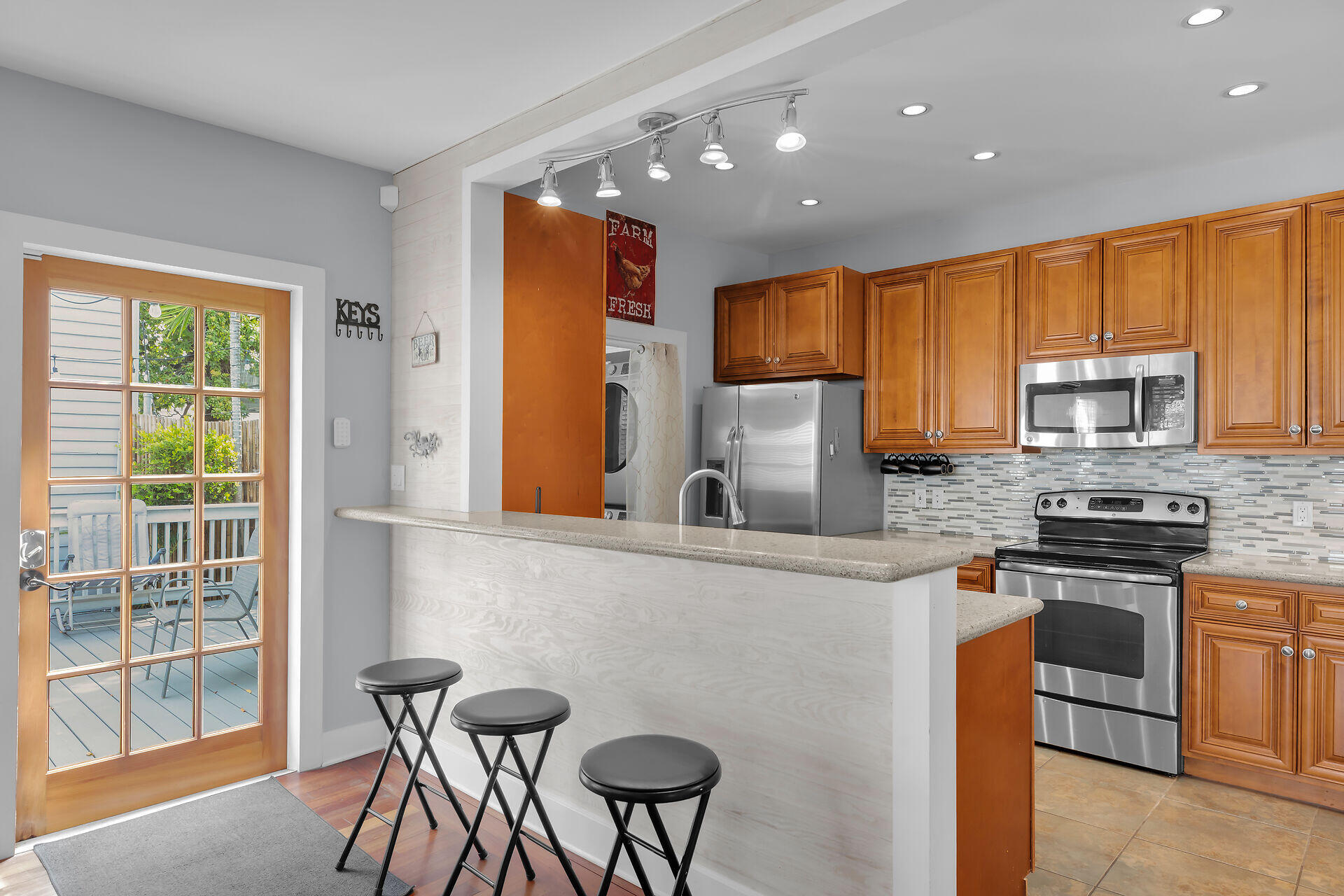 1124 Eaton Street Key West, FL 33040 - Photo 7 of 28 a kitchen with stainless steel appliances granite countertop a stove a sink a microwave a refrigerator and cabinets