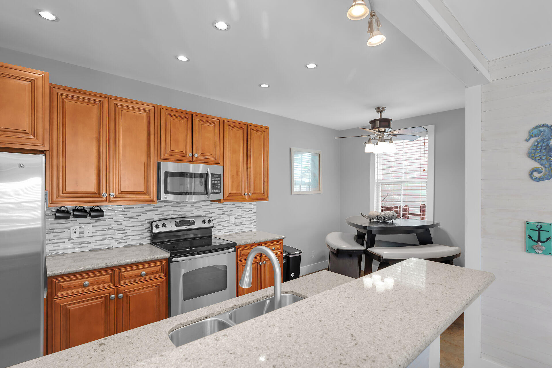 1124 Eaton Street Key West, FL 33040 - Photo 8 of 28 a kitchen with stainless steel appliances granite countertop sink stove top oven and cabinets