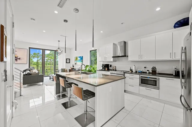a kitchen with white cabinets and white appliances