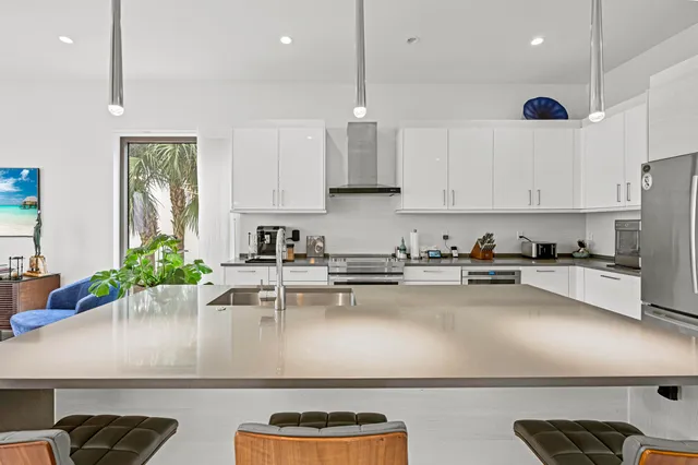 a kitchen with stainless steel appliances a sink a stove and refrigerator
