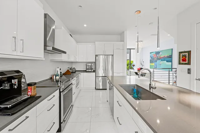 a kitchen with stainless steel appliances a sink stove and cabinets