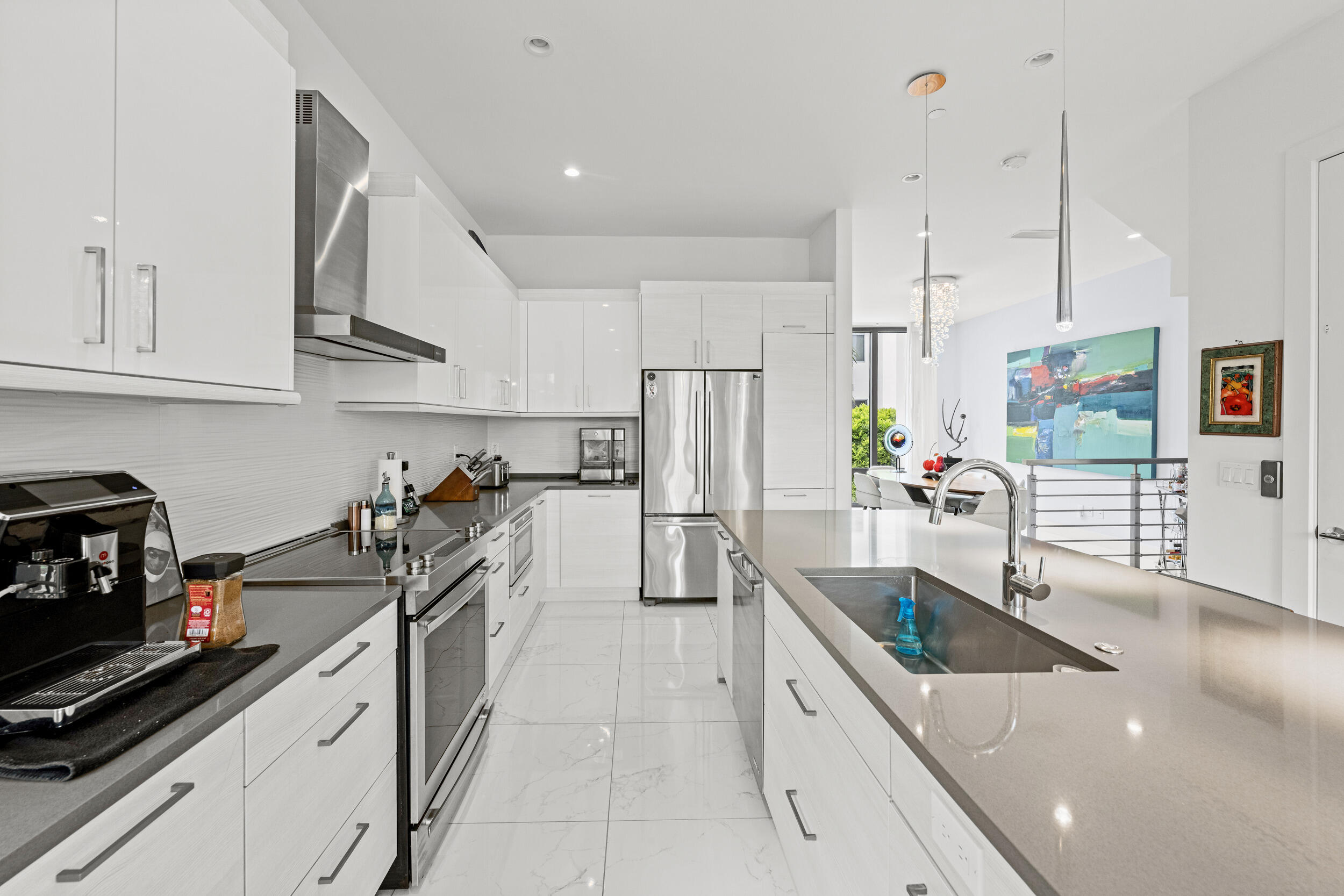 1811 Northwest 42nd Drive Boca Raton, FL 33431 - Photo 15 of 52 a kitchen with stainless steel appliances a sink a stove and refrigerator