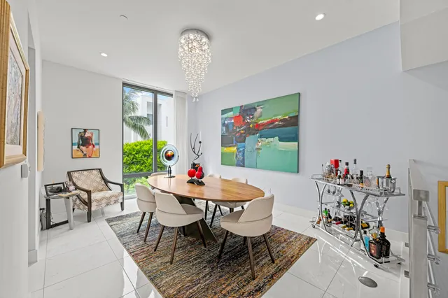 a view of a dining room with furniture and a potted plant
