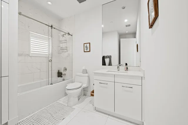 a spacious bedroom with a bed and dresser