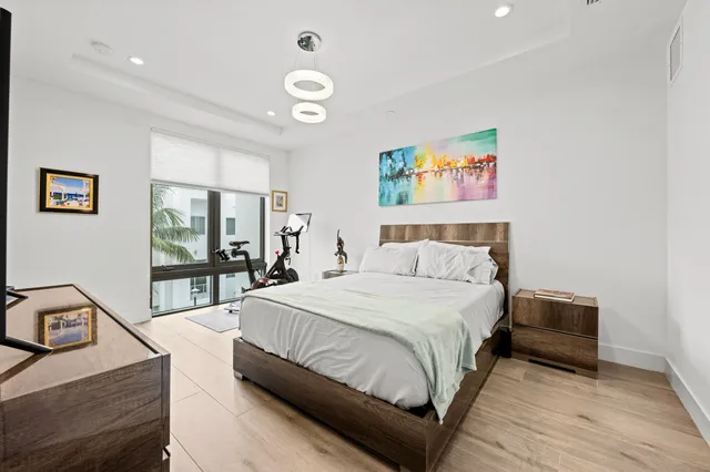 a bedroom with a bed and a chandelier