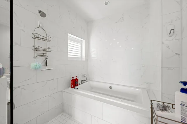 a spacious bathroom with a double vanity sink toilet and shower