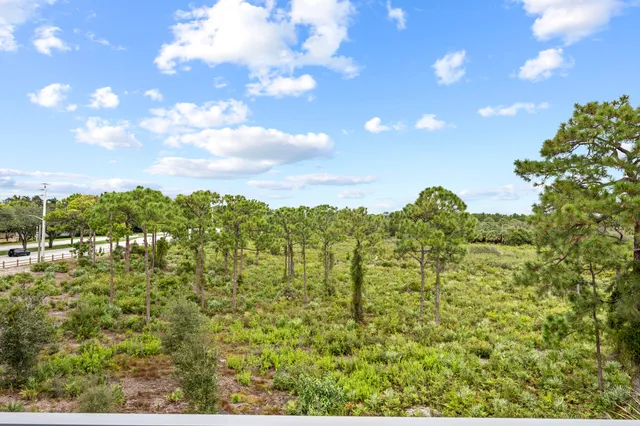 a view of a chairs and table in patio with a lake view
