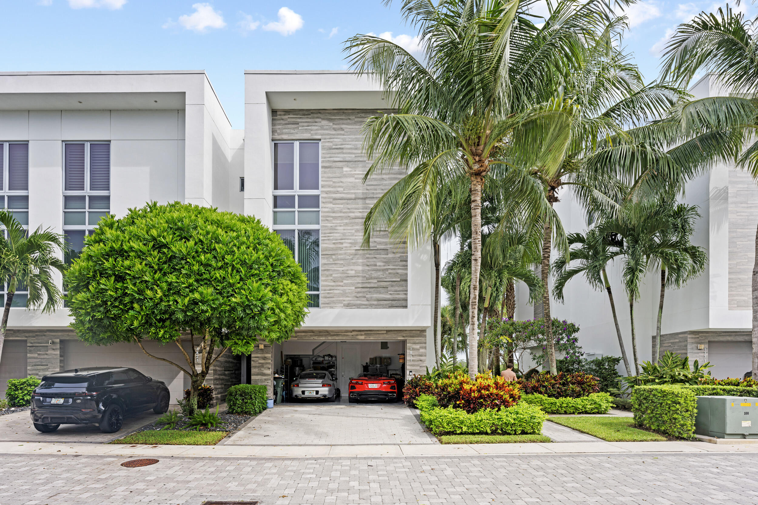 1811 Northwest 42nd Drive Boca Raton, FL 33431 - Photo 4 of 52 a front view of a house with a garden