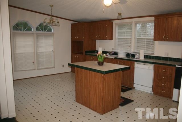 54 Gm Robertson Road Roxboro, NC 27574 - Photo 7 of 17 a kitchen with stainless steel appliances granite countertop a sink a stove and a refrigerator