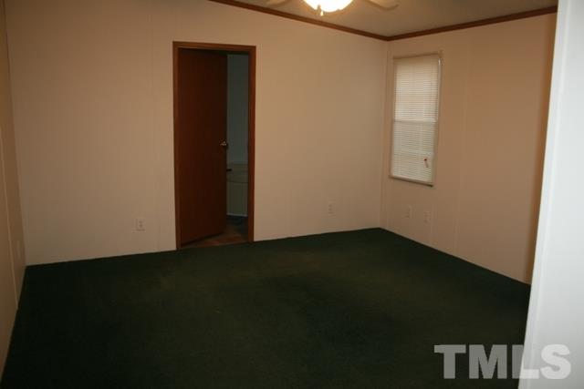 54 Gm Robertson Road Roxboro, NC 27574 - Photo 9 of 17 a view of an empty room with wooden floor and a window