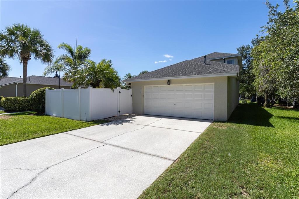 10121 Porch Street New Port Richey, FL 34655 - Photo 48 of 57 a front view of a house with a yard and a garage