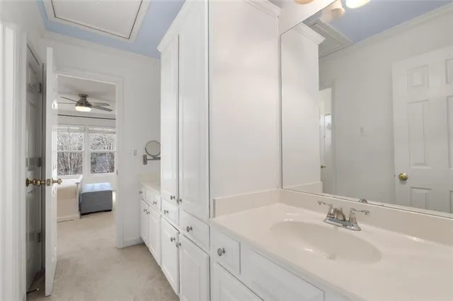 a view of a patio with table and chairs potted plants and a large tree