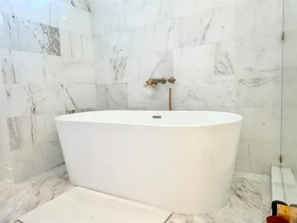 a white bath tub sitting in a bathroom