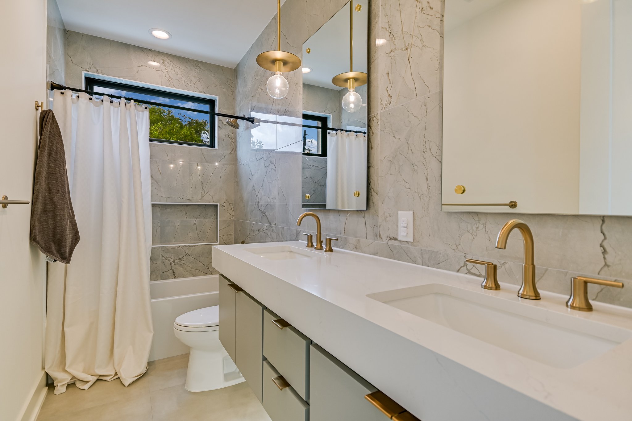 2015 De Verne Street Austin, TX 78704 - Photo 15 of 21 Bathroom with tile walls, double vanity, shower / tub combo, and recessed lighting
