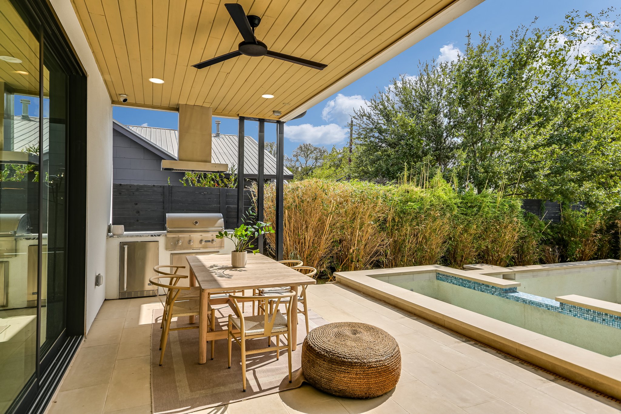 2015 De Verne Street Austin, TX 78704 - Photo 18 of 21 Fenced backyard with exterior kitchen, a ceiling fan, a patio, an outdoor pool, and outdoor dining area