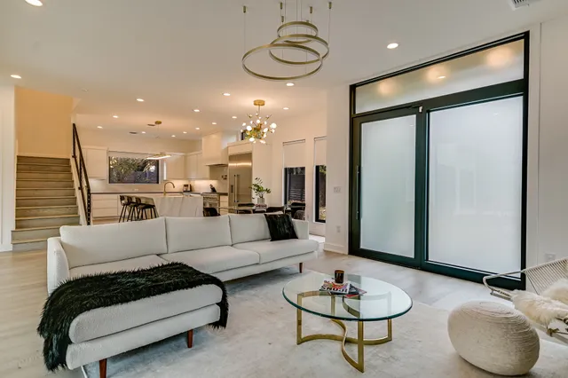 a living room with furniture and a chandelier