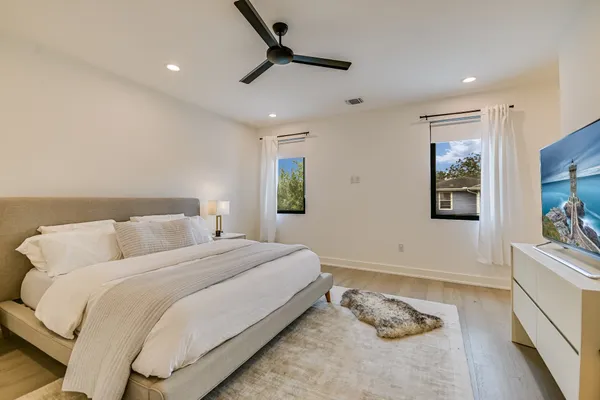a bedroom with a bed and a flat screen tv