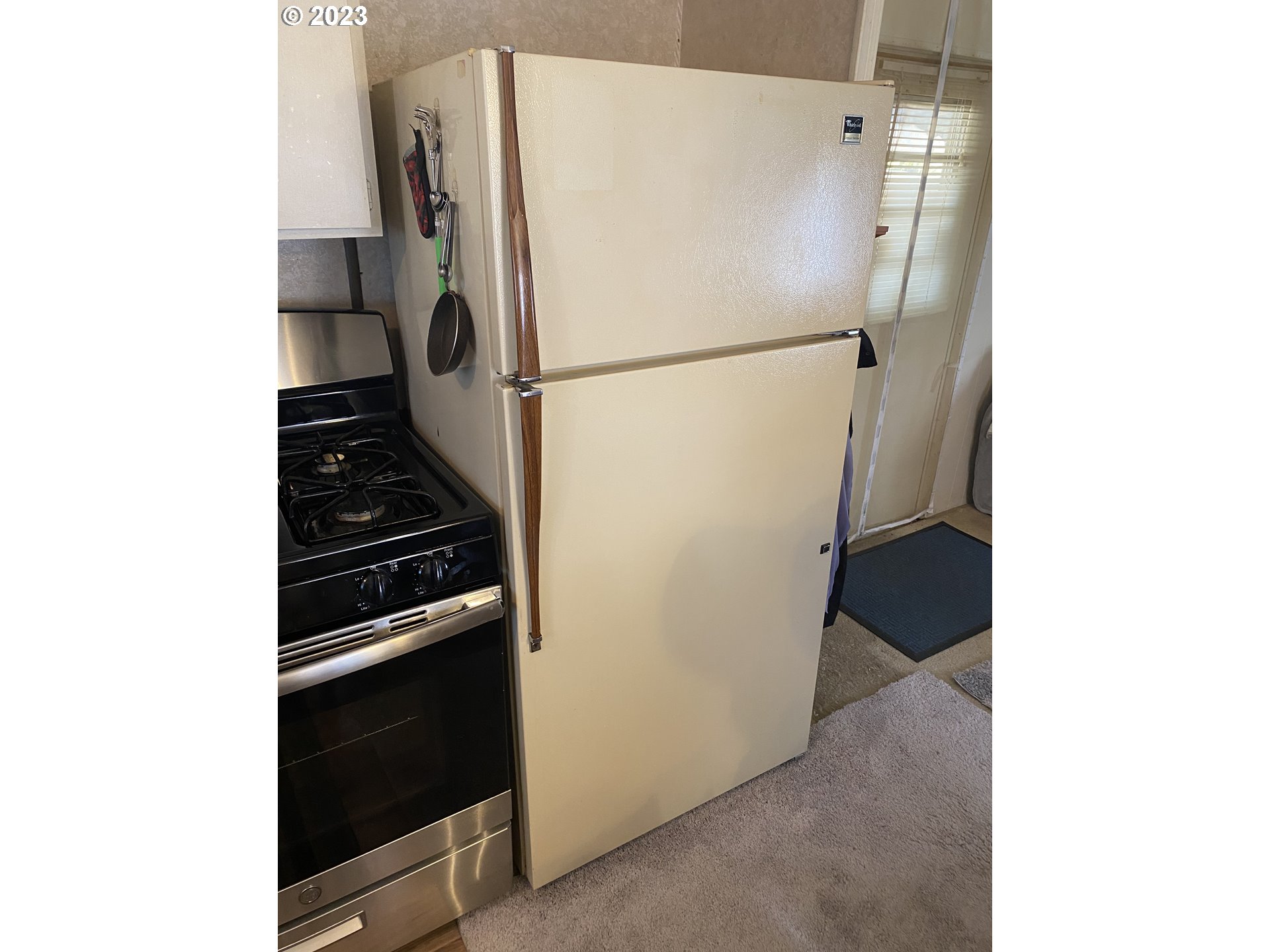 3900 Coburg Road, Unit 52 Eugene, OR 97408 - Photo 13 of 17 a white refrigerator freezer and a stove sitting inside of a kitchen