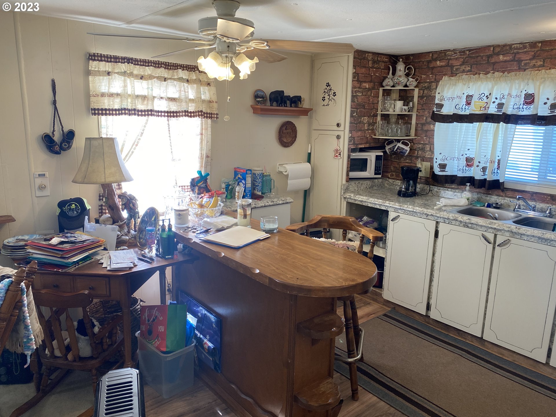 3900 Coburg Road, Unit 52 Eugene, OR 97408 - Photo 10 of 17 a room with stainless steel appliances kitchen island a table and chairs in it