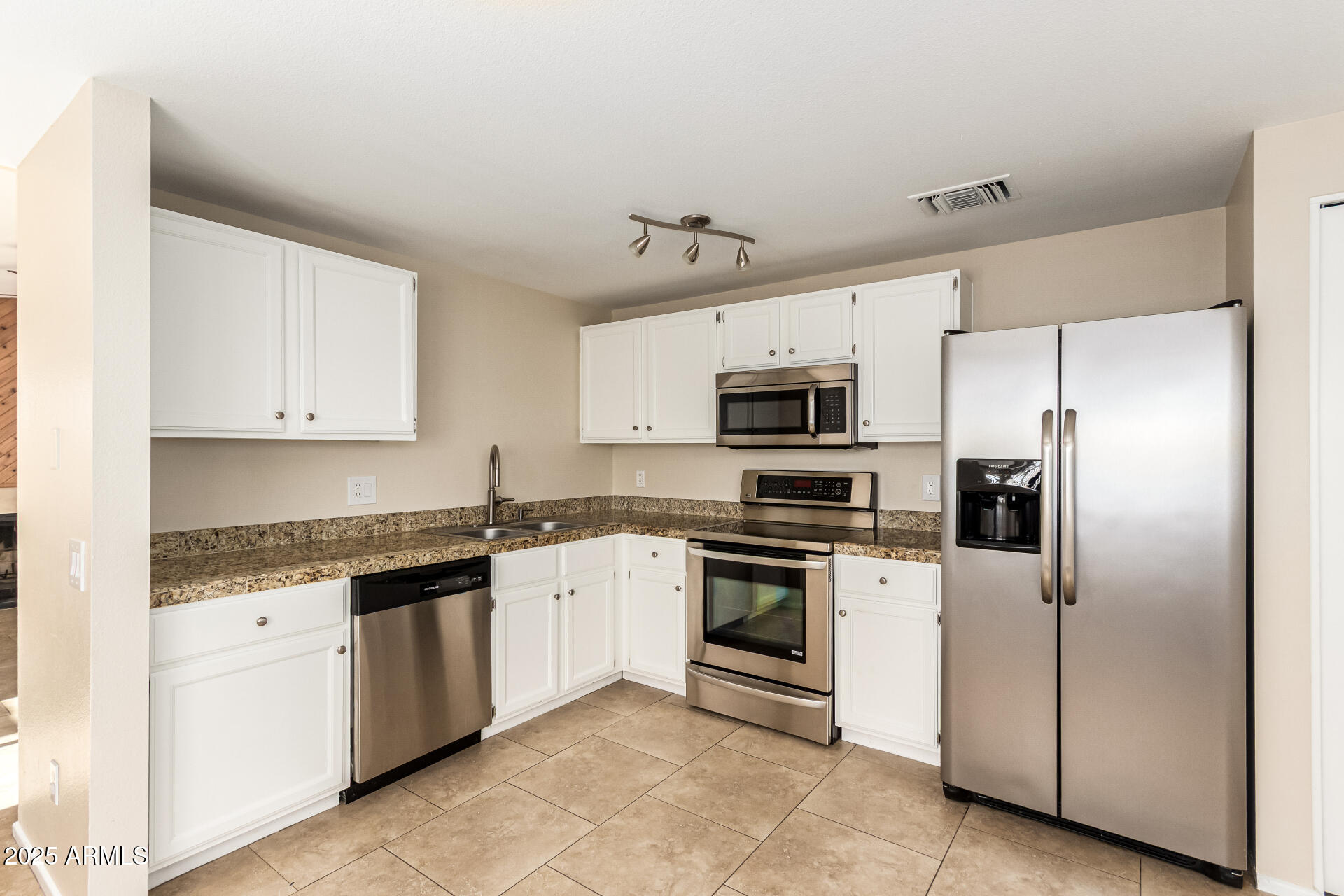 2133 North Apollo Court Chandler, AZ 85224 - Photo 11 of 23 a kitchen with stainless steel appliances granite countertop a stove a sink and a refrigerator