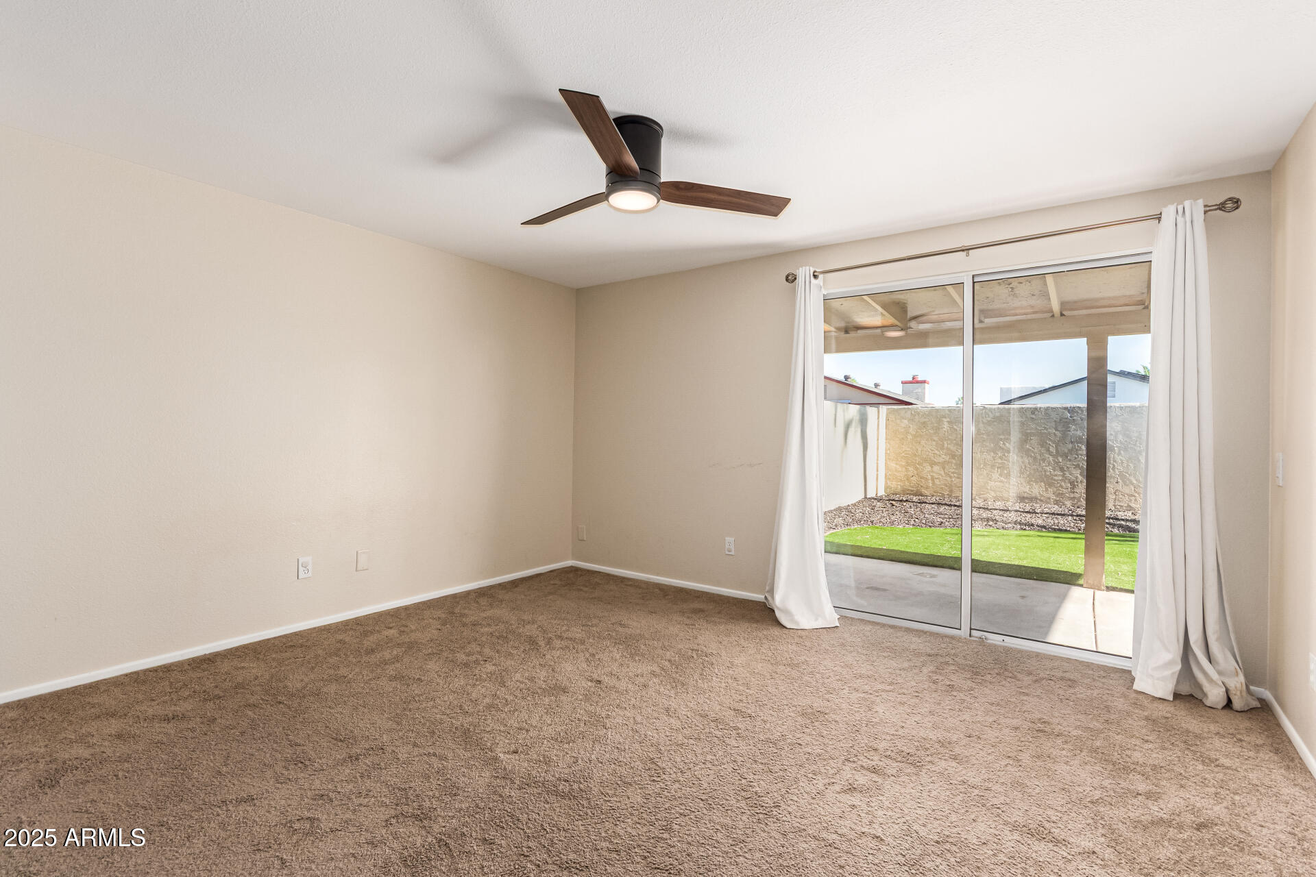 2133 North Apollo Court Chandler, AZ 85224 - Photo 12 of 23 an empty room with floor to ceiling window and ceiling fan