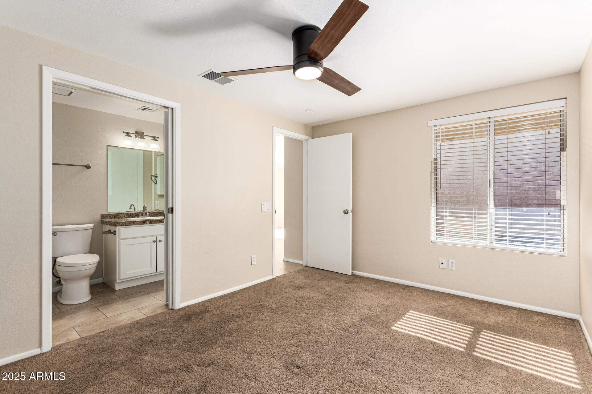 2133 North Apollo Court Chandler, AZ 85224 - Photo 17 of 23 a bathroom with a toilet sink a mirror and a shower