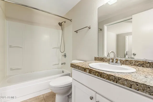 a view of a backyard with a tub potted plants and a large tree