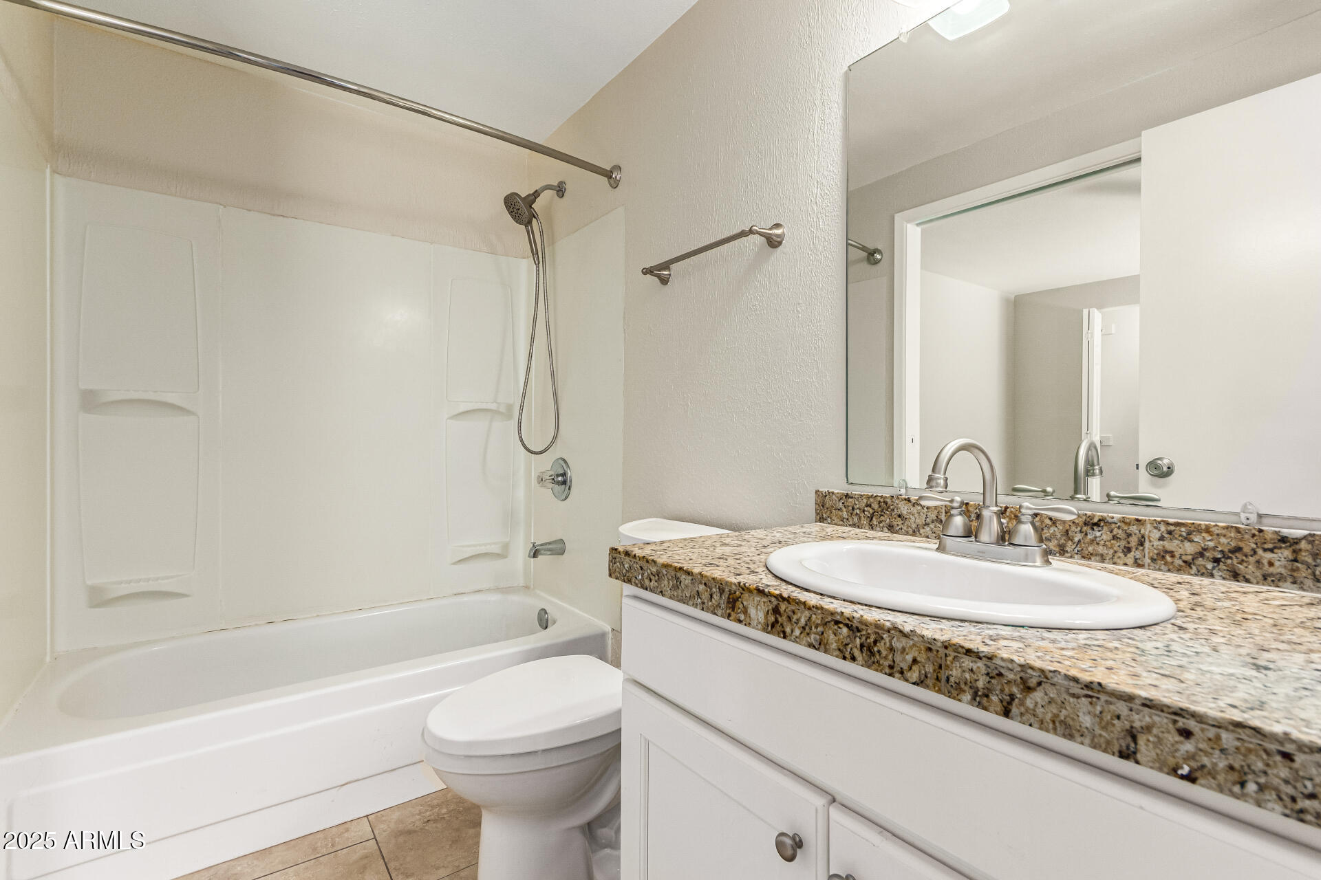 2133 North Apollo Court Chandler, AZ 85224 - Photo 19 of 23 a bathroom with a granite countertop sink a toilet a mirror a bathtub and shower