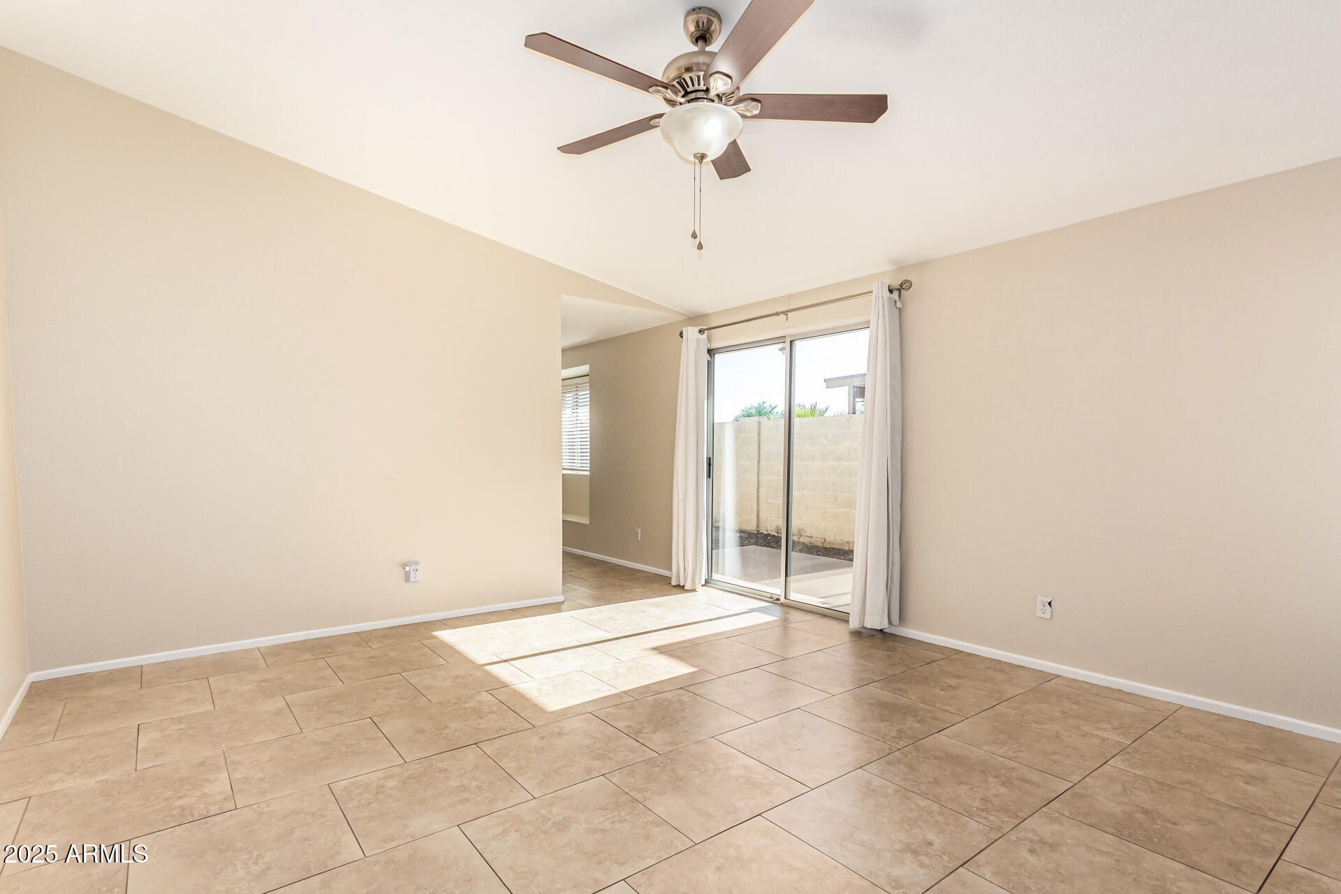 2133 North Apollo Court Chandler, AZ 85224 - Photo 5 of 23 an empty room with a ceiling fan and carpet