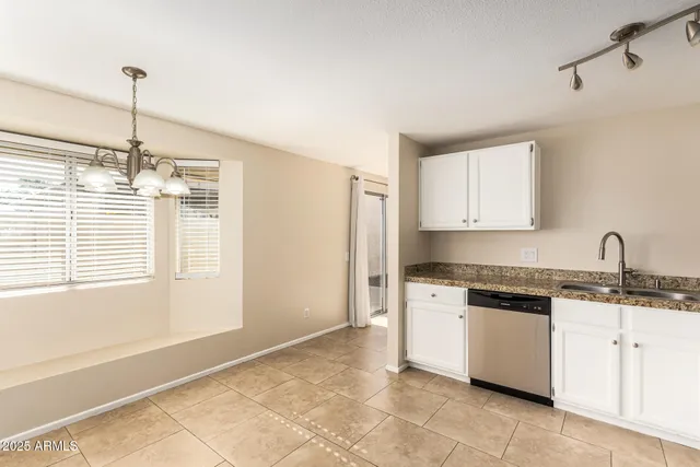 a kitchen with stainless steel appliances granite countertop a stove sink and refrigerator