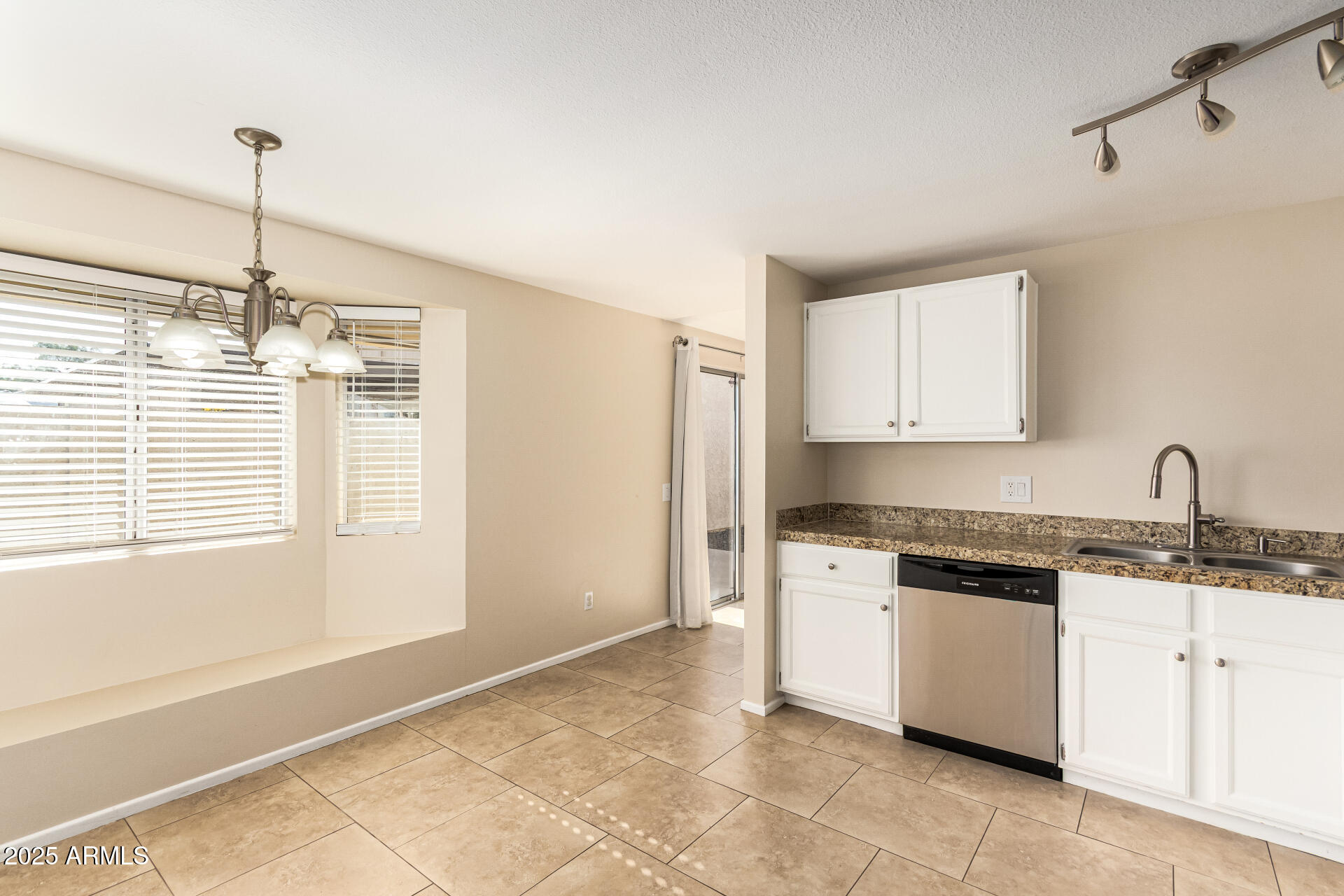 2133 North Apollo Court Chandler, AZ 85224 - Photo 9 of 23 a kitchen with granite countertop a sink stainless steel appliances and cabinets