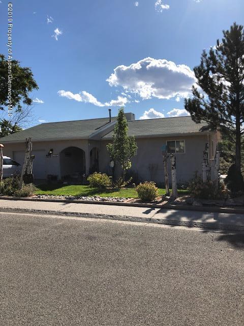1424 Arabian Avenue Rifle, CO 81650 - Photo 1 of 14 a view of a house with a yard and garage