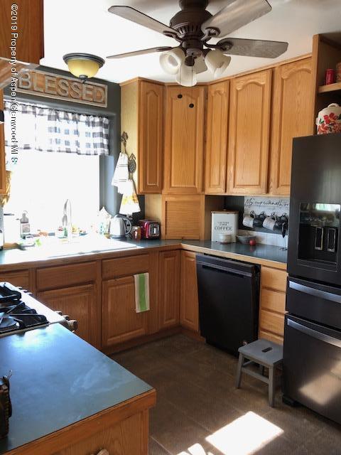 1424 Arabian Avenue Rifle, CO 81650 - Photo 4 of 14 a kitchen with a sink appliances cabinets and a large window