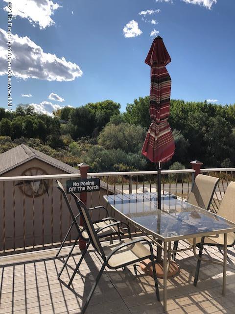 1424 Arabian Avenue Rifle, CO 81650 - Photo 8 of 14 a view of a roof deck with couches chairs and wooden floor