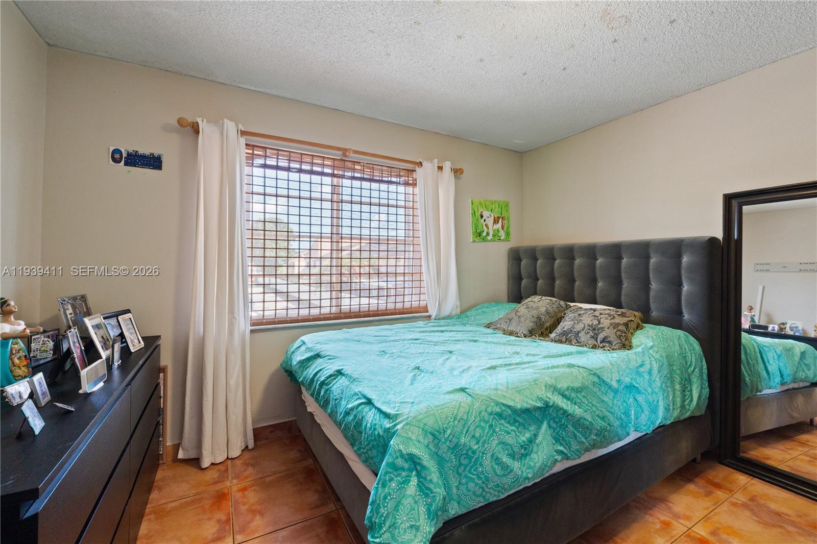 8480 Southwest 156th Place, Unit 620 Miami, FL 33193 - Photo 12 of 23 a bedroom with a bed and a dresser next to a window