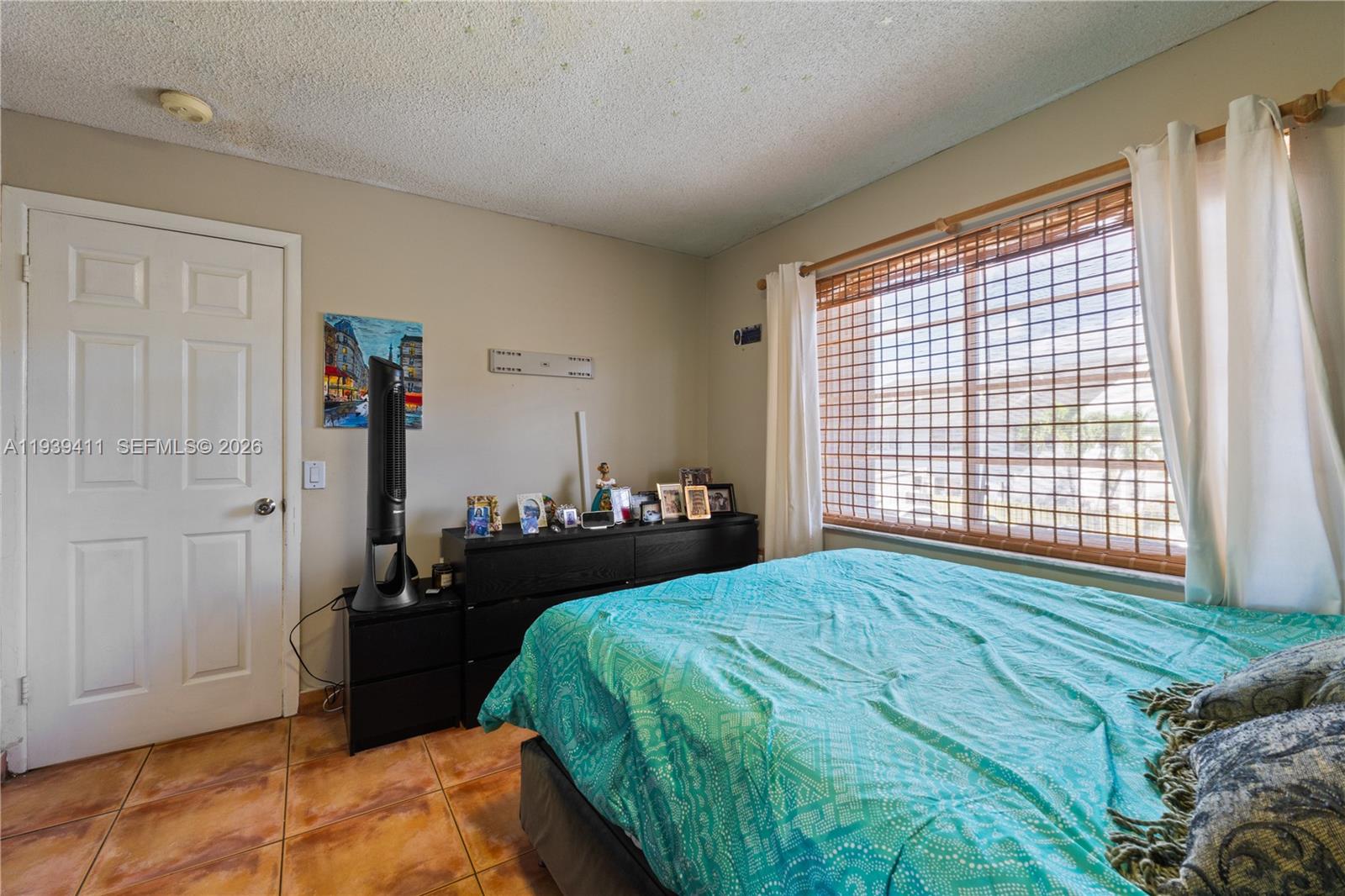 8480 Southwest 156th Place, Unit 620 Miami, FL 33193 - Photo 13 of 23 a bedroom with a bed and wooden floor