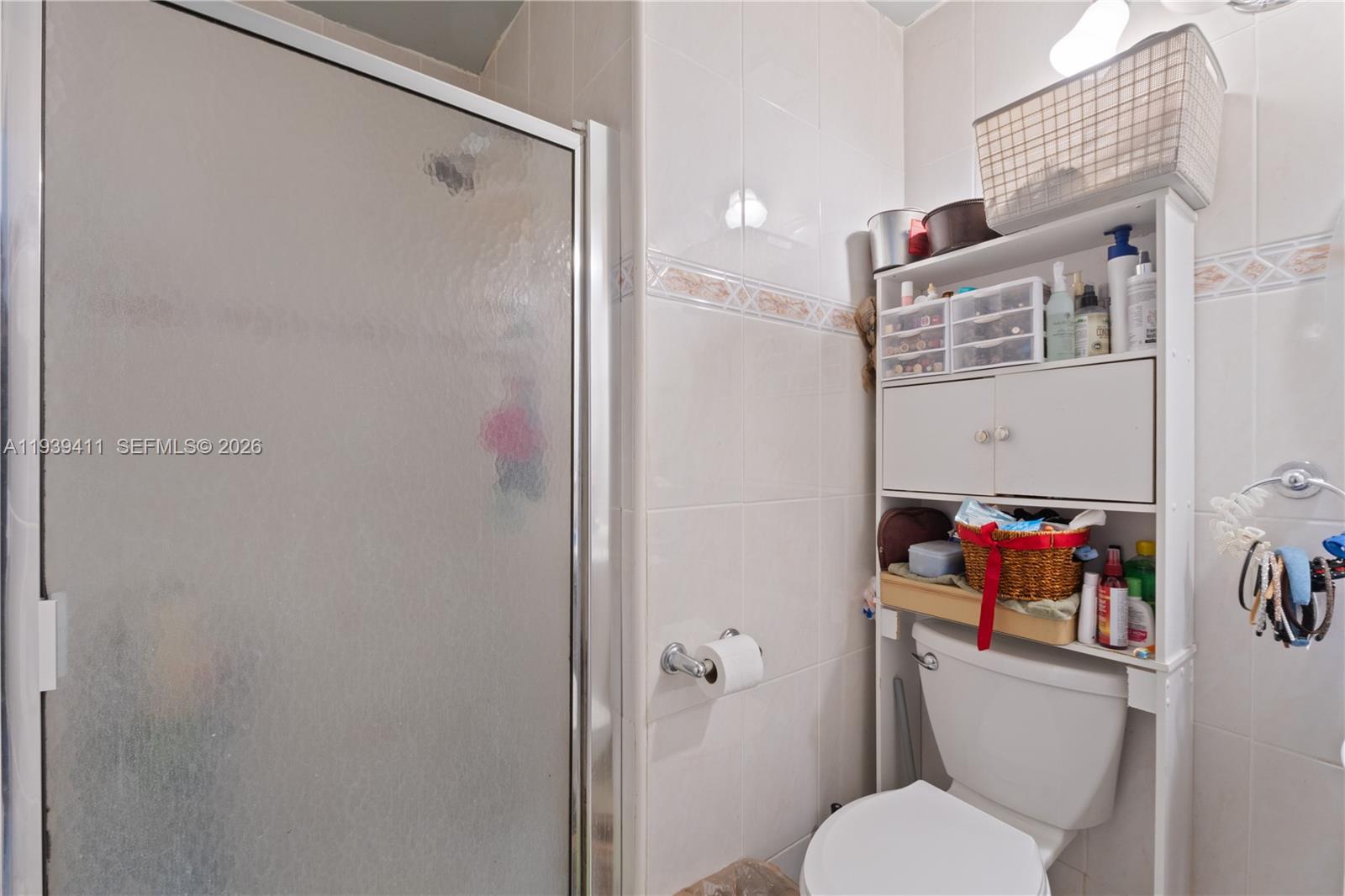 8480 Southwest 156th Place, Unit 620 Miami, FL 33193 - Photo 15 of 23 a white toilet sitting next to a bathroom sink